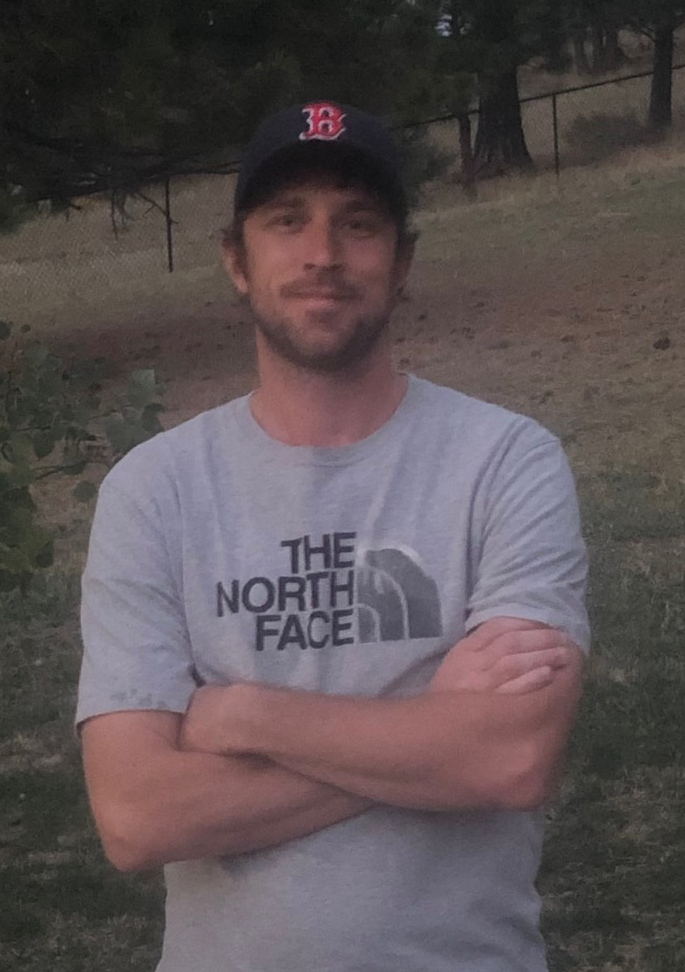 Picture of Matt Forba with arms cross, wearing a Boston Red Sox ball cap and a grey North Face t-shirt.